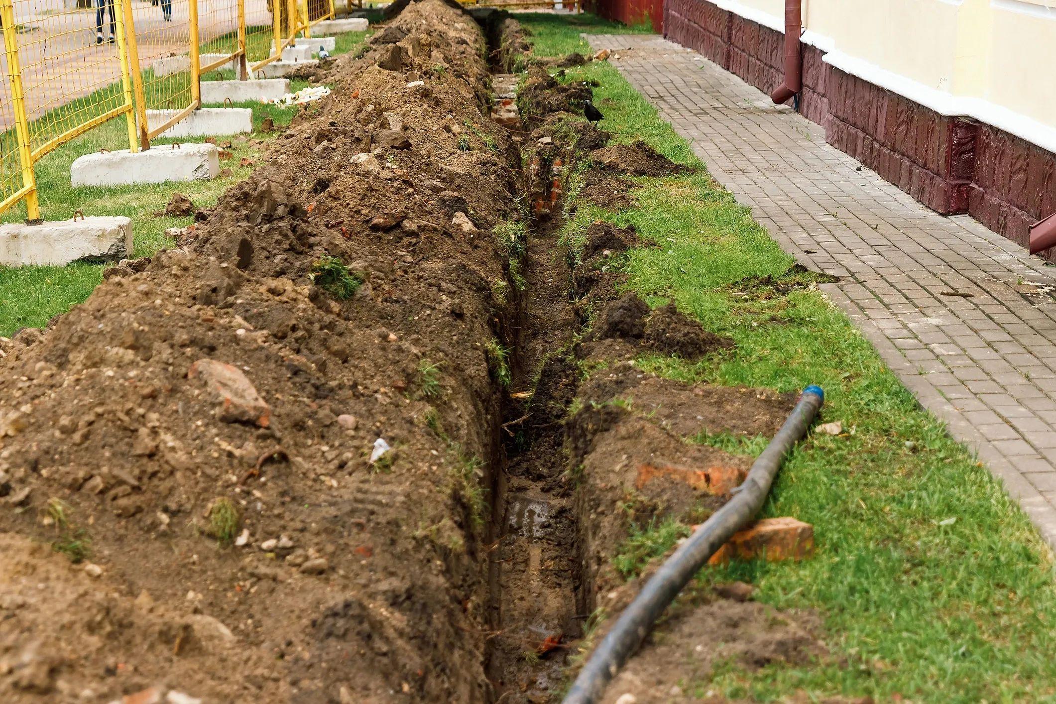 Excavation trench along the foundation of a home