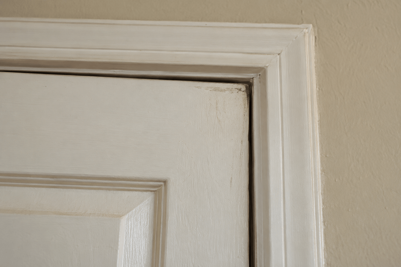 Uneven gap around the upper corner of a sticking door